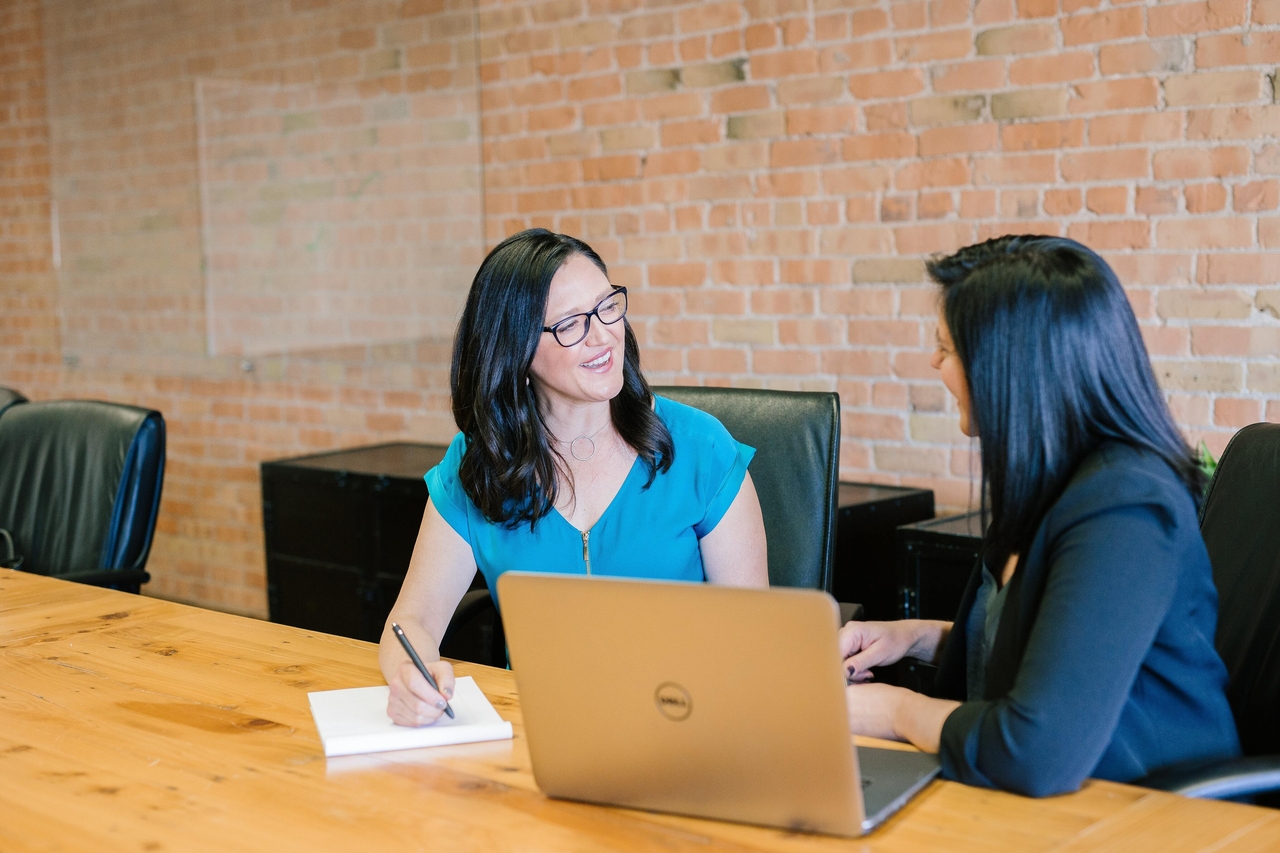 Two women speaking in an office